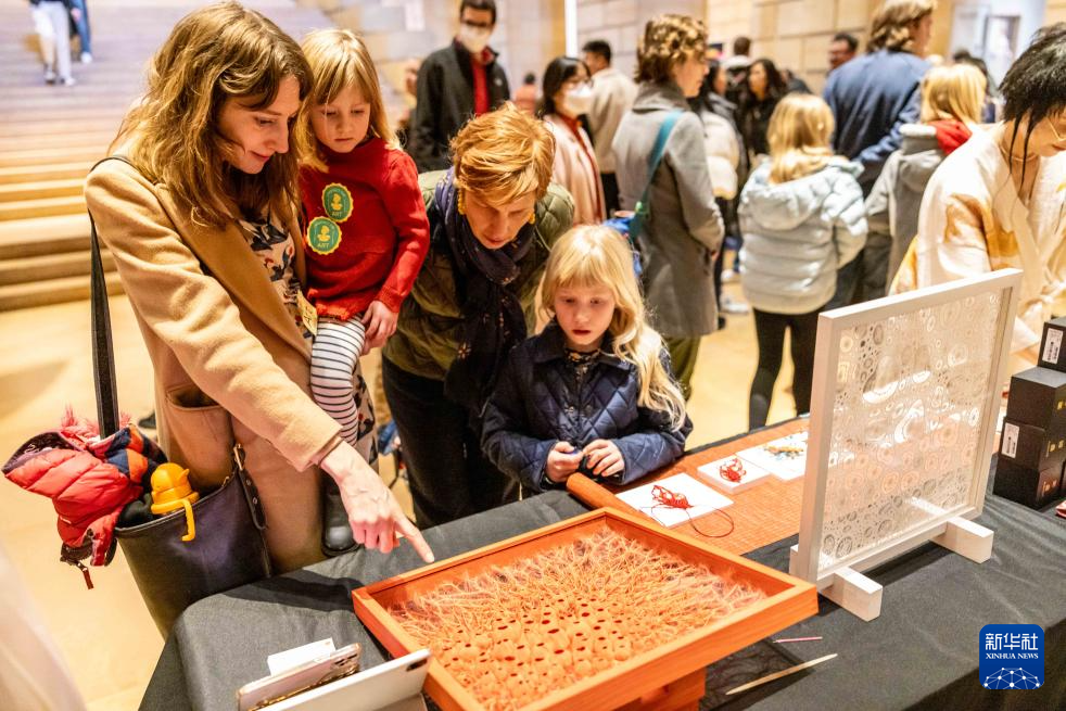 2月11日，參觀者在美國費城藝術博物館舉行的龍年迎新春活動上觀看刺繡作品。新華社發(fā)（周煥新攝）