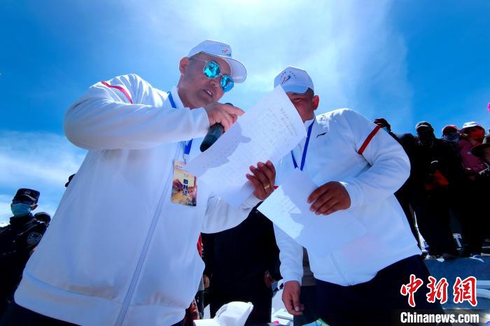 圖為裁判員統(tǒng)計牧民運動項目比賽成績?！±铍h 攝