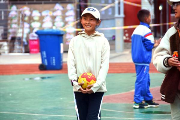 在高原上教孩子們打手球，“慢慢兒來，甭著急！”