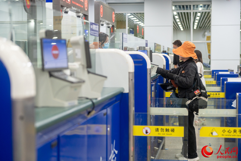 越南游客正在辦理入境手續(xù)。人民網(wǎng)記者 嚴(yán)立政攝