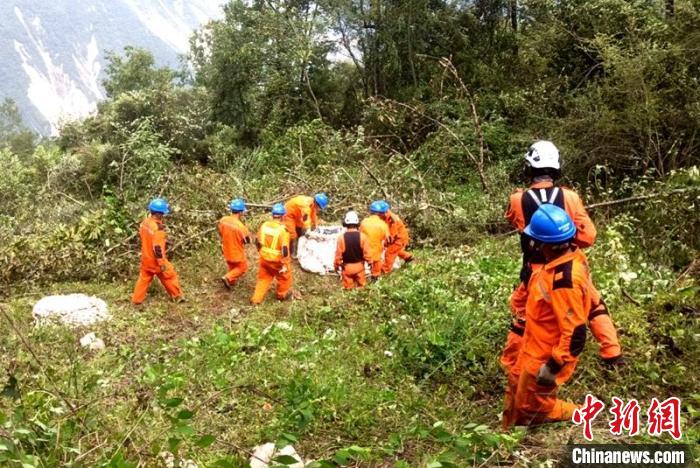 海拔1950米唐29號塔位搶險隊員正搬運直升機吊運上山的搶險材料。　徐慶明 攝