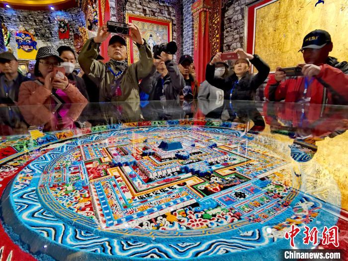 圖為參觀者拍攝壇城?！?zhí)砀?攝