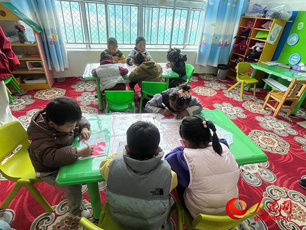 拉多村一所現(xiàn)代化幼兒園小班孩子們正在繪畫。張敏穎 攝